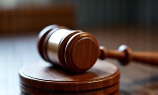 Legal gavel on wooden desk, close-up for mobile view